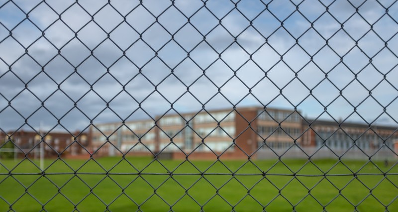 high-school-building-behind-a-fence