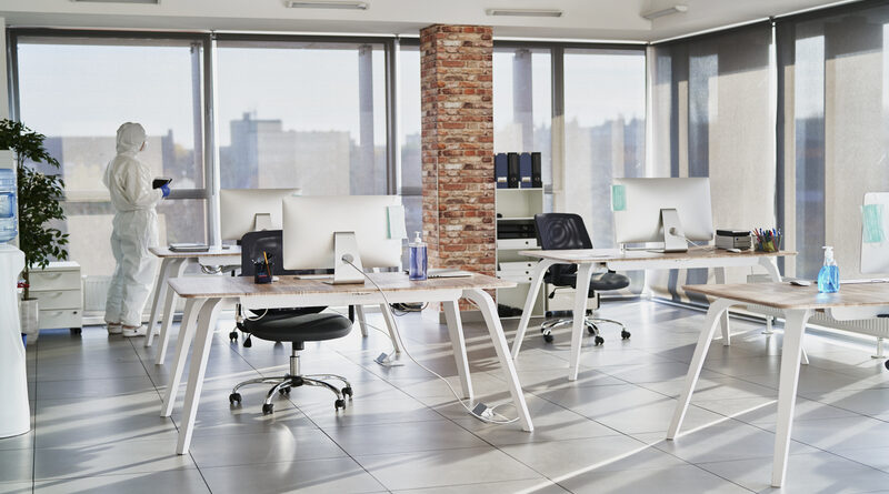 Person in protective workwear alone in an empty office